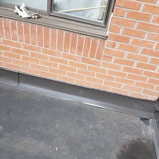 Close-up of flashing repair around a brick window sill